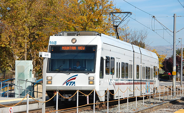 light rail transit train in dedicated right-of-way, powered by overhead lines